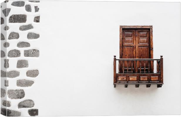 Wooden window door and balcony in a white wall. La Canvas Print by Liam Grant
