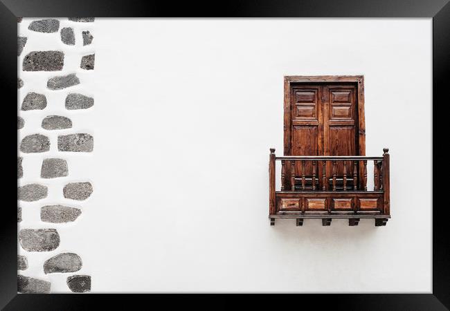 Wooden window door and balcony in a white wall. La Framed Print by Liam Grant