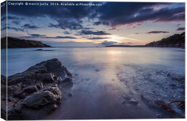 Sunset at rocky beach with slow motion blur water Canvas Print by marcin jucha