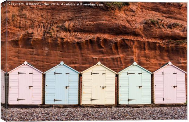 Beach hut row in pastel colors, red rock backgroun Canvas Print by marcin jucha