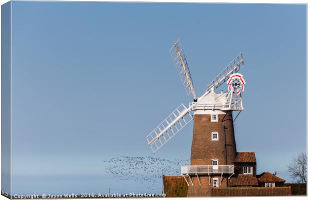 Flock of birds take to the skies behind Cley windm Canvas Print by Jason Wells
