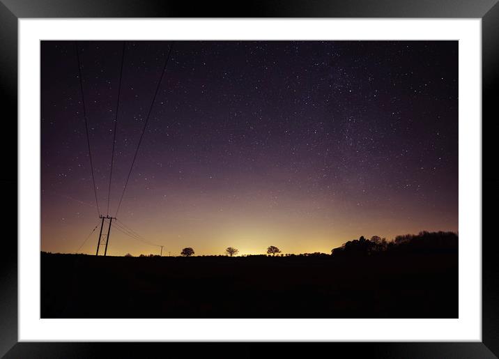 Star filled sky with tree silhouettes on the horiz Framed Mounted Print by Liam Grant