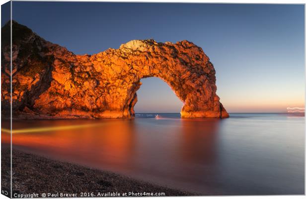 Durdle Door Dorset with an illuminated Canoeist   Canvas Print by Paul Brewer