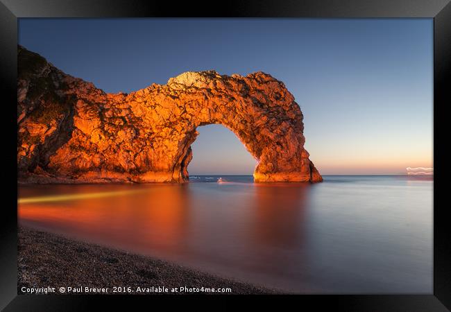 Durdle Door Dorset with an illuminated Canoeist   Framed Print by Paul Brewer