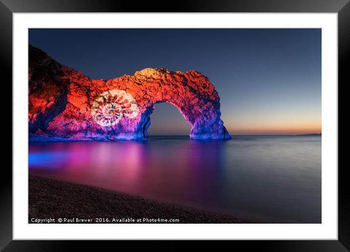 Durdle Door illuminated at night Framed Mounted Print by Paul Brewer