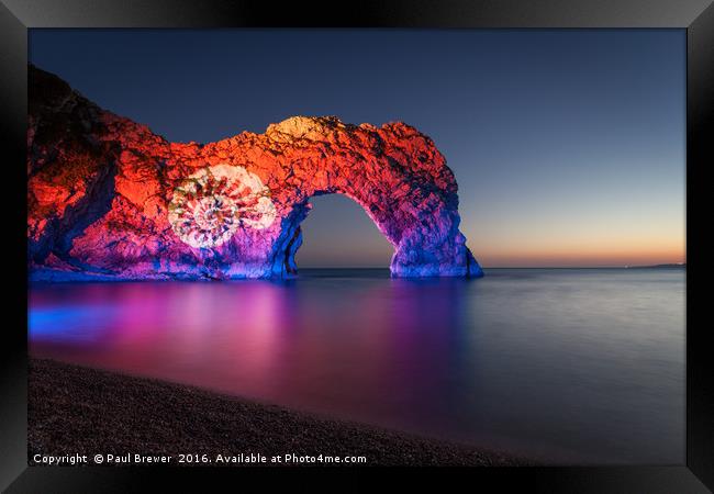 Durdle Door illuminated at night Framed Print by Paul Brewer