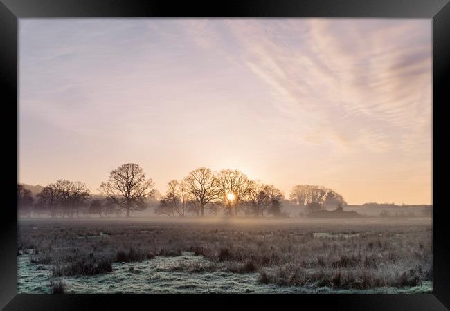 Sunrise and mist on a frosty morning. Norfolk, UK. Framed Print by Liam Grant