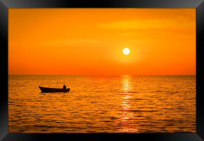 Sea sunset with a fishermans boat silhouette. Framed Print by Tartalja 