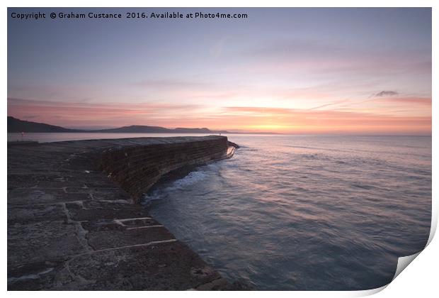 Sunrise at The Cobb, Lyme Regis Print by Graham Custance