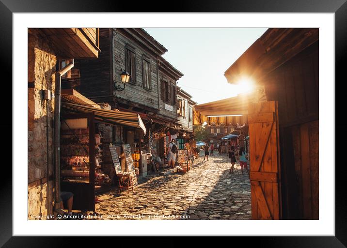 People walk through streets of ancient Nessebar Framed Mounted Print by Andrei Bortnikau