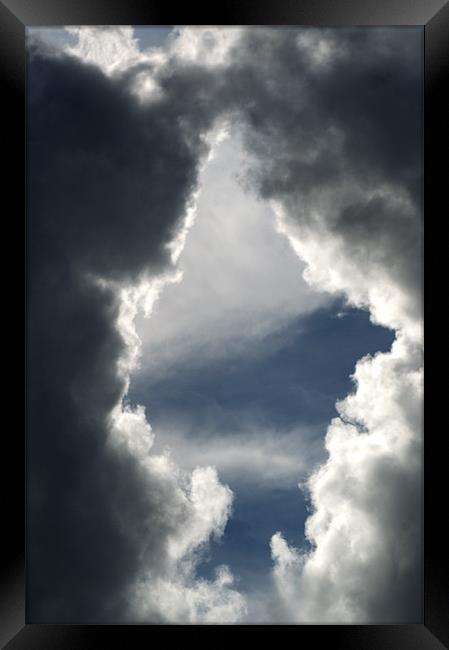 Clouds Through the Keyhole Framed Print by Chris Day