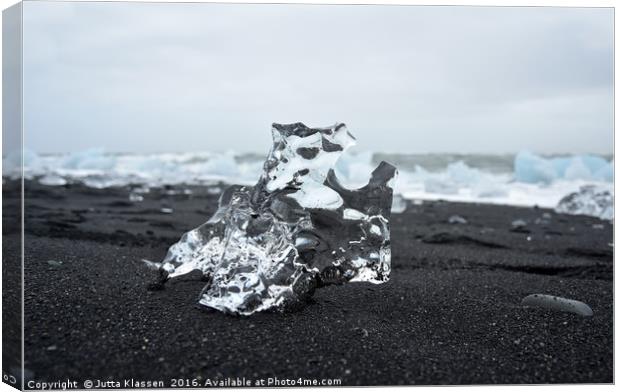 Crystal ice on black sand Canvas Print by Jutta Klassen