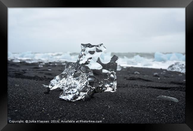 Crystal ice on black sand Framed Print by Jutta Klassen