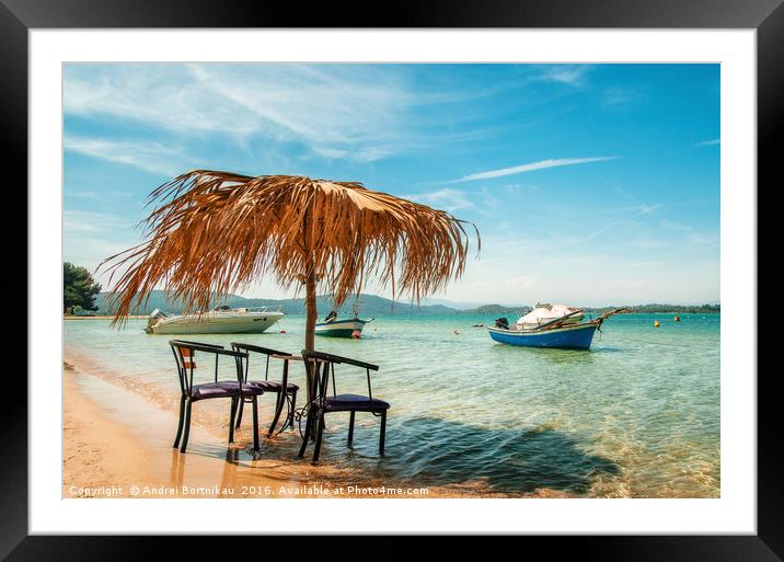 Сhairs under thatched umbrellas in a turquoise sea Framed Mounted Print by Andrei Bortnikau