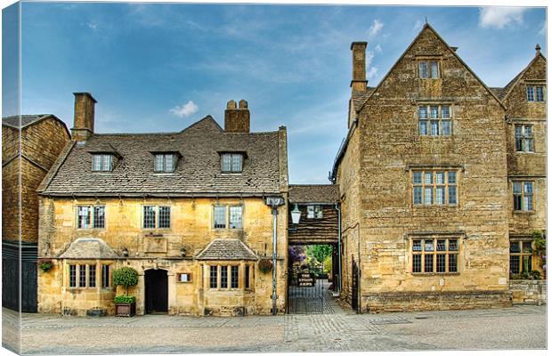 Cotswolds hostelry - 16th century coaching inn. Canvas Print by John Edwards