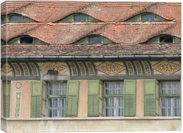 Roof Eyes in Sighisoara, Romania Canvas Print by Chris Langley