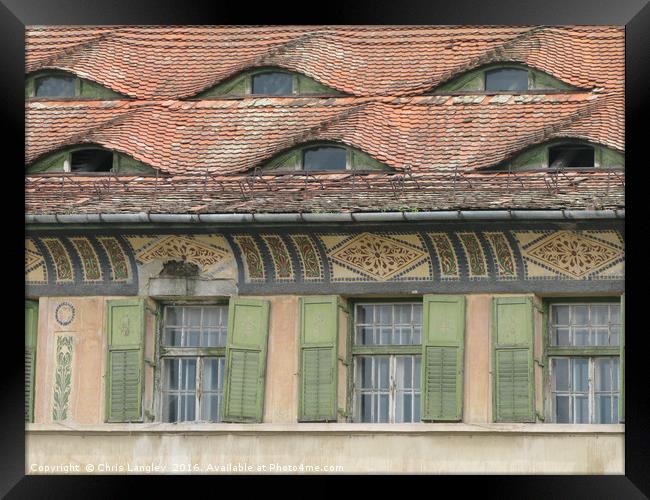 Roof Eyes in Sighisoara, Romania Framed Print by Chris Langley