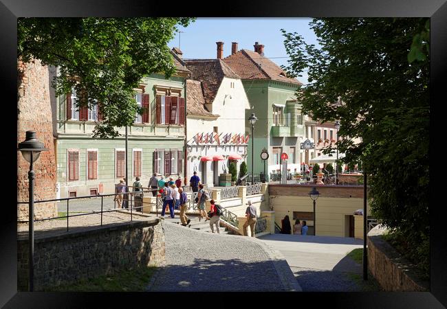 Tourists visiting Old Town Sibiu Romania Framed Print by Adrian Bud