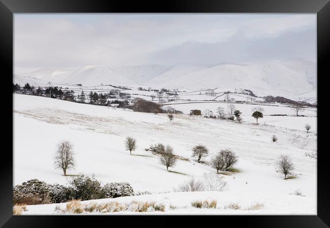 Snow covered mountains and farmland. Cumbria, UK. Framed Print by Liam Grant