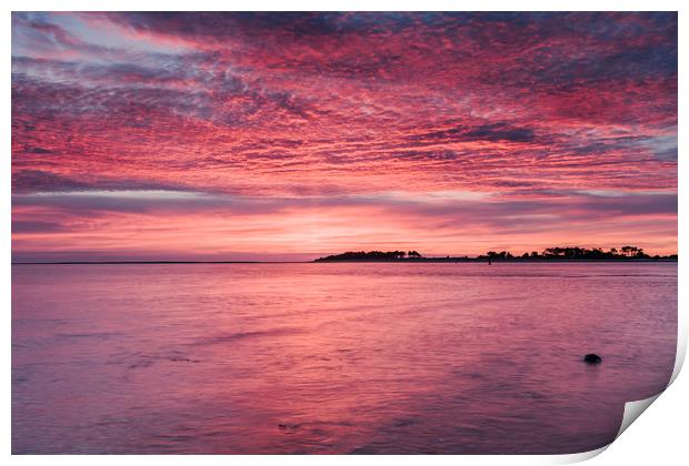 Pink dawn sky reflected in the surface of the sea. Print by Liam Grant