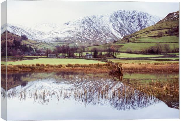 Farm and snow covered mountain reflections in Brot Canvas Print by Liam Grant