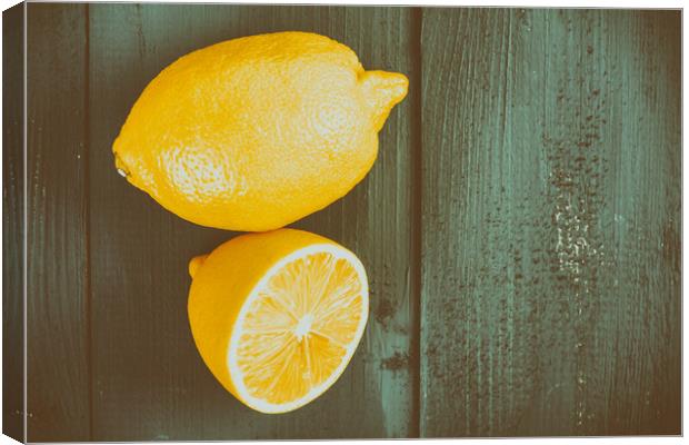 Fresh Yellow Lemons On Wooden Table Canvas Print by Radu Bercan