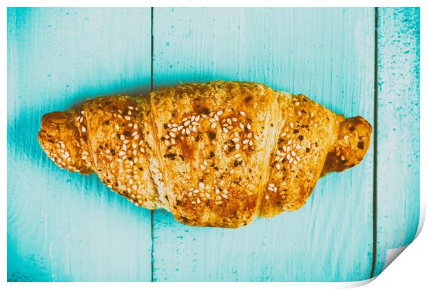 Croissant On Blue Table Print by Radu Bercan