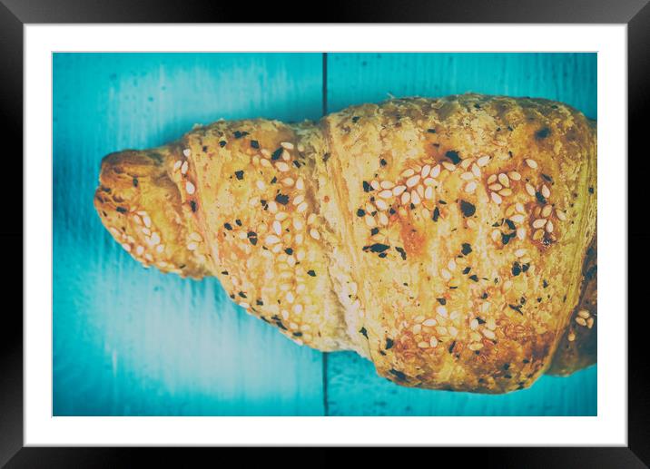 Croissant On Blue Table Framed Mounted Print by Radu Bercan