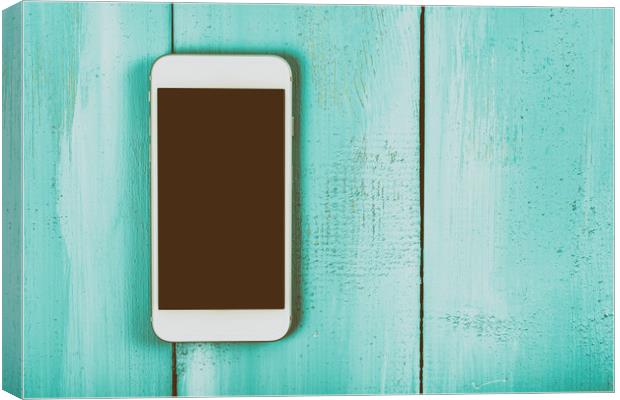 White Mobile Phone With Blank Screen On Wood Table Canvas Print by Radu Bercan