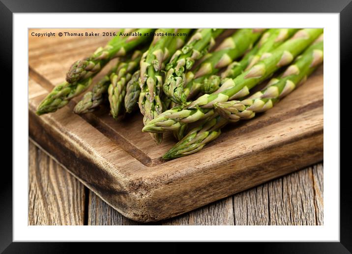 Fresh Asparagus on rustic wooden server board Framed Mounted Print by Thomas Baker