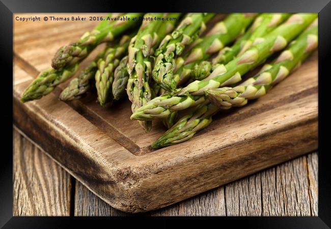 Fresh Asparagus on rustic wooden server board Framed Print by Thomas Baker