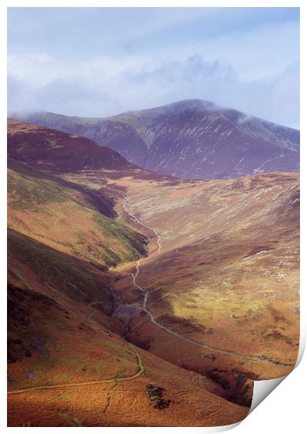 Distant tracks leading up a mountainside in Autumn Print by Liam Grant