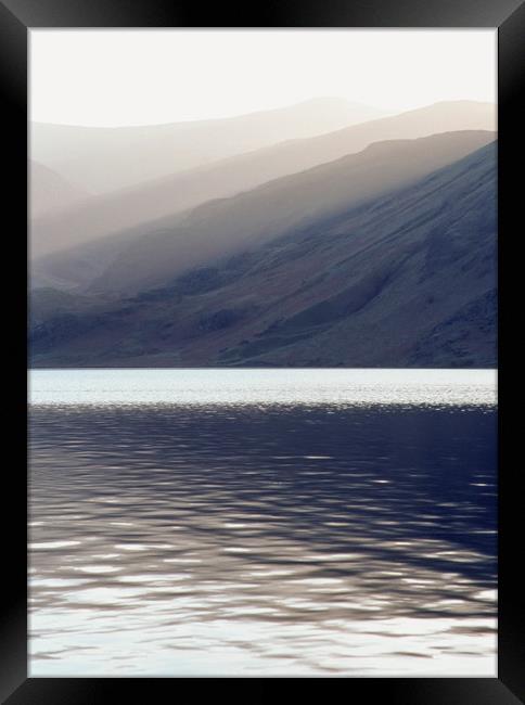 Shafts of sunlight at sunset of Crummock Water. Cu Framed Print by Liam Grant