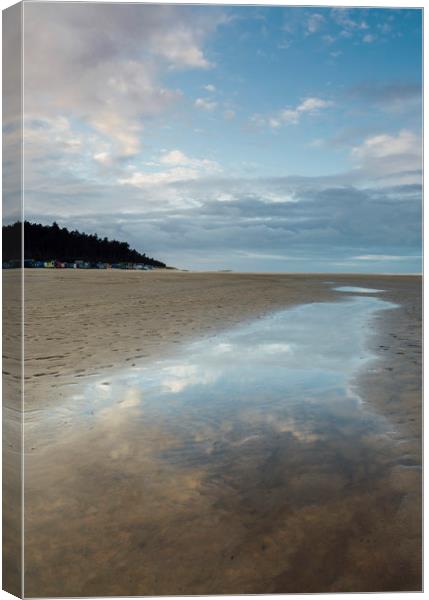 Sunset sky reflected in a water at low tide. Wells Canvas Print by Liam Grant