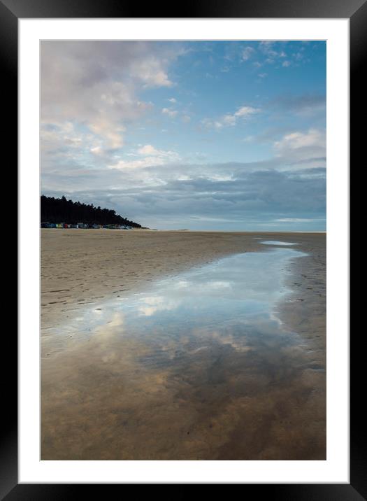 Sunset sky reflected in a water at low tide. Wells Framed Mounted Print by Liam Grant