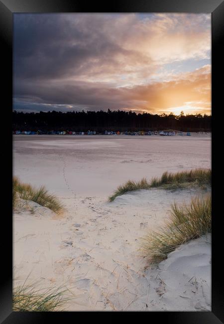 Sunset, beach huts and footprints in the sand. Nor Framed Print by Liam Grant