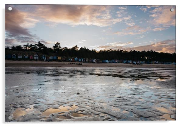 Sunset sky and beach huts reflected in a water at  Acrylic by Liam Grant