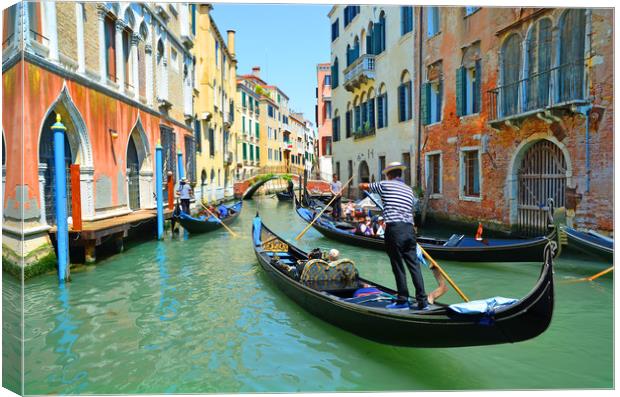 Gondolas on the canal                         Canvas Print by Michael Oakes