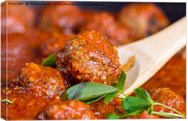 Freshly cooked meatballs in red sauce  Canvas Print by Thomas Baker