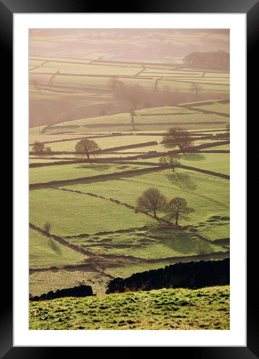 Hazy light at sunset over a vallery of fields. Der Framed Mounted Print by Liam Grant