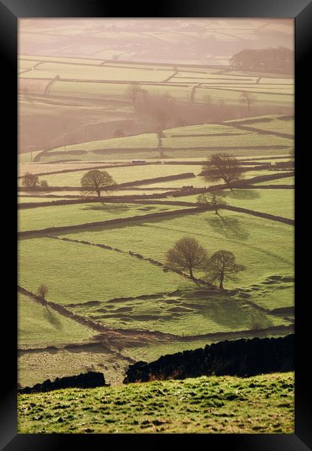 Hazy light at sunset over a vallery of fields. Der Framed Print by Liam Grant
