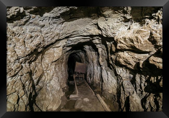 Mine cart in an old abandoned mine cave. Near Matl Framed Print by Liam Grant