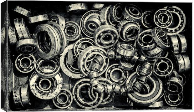 Pile of Old Rusty Ball Bearing Wheels Canvas Print by John Williams