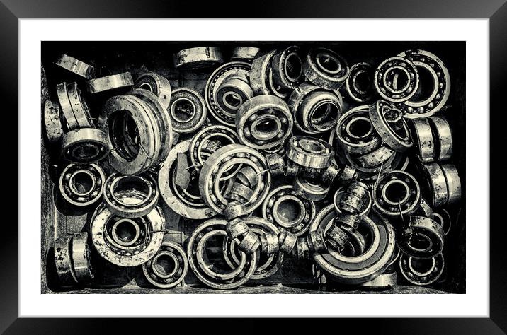 Pile of Old Rusty Ball Bearing Wheels Framed Mounted Print by John Williams