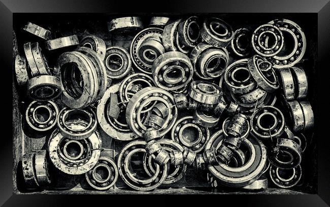 Pile of Old Rusty Ball Bearing Wheels Framed Print by John Williams