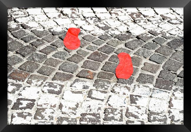 Red footsteps in town Framed Print by Massimo Lama
