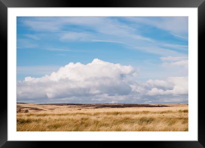 Blue sky and white clouds above sunlit moorland. D Framed Mounted Print by Liam Grant