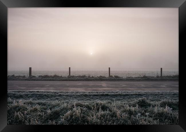 Sunrise through fog on a frosty morning. Norfolk,  Framed Print by Liam Grant