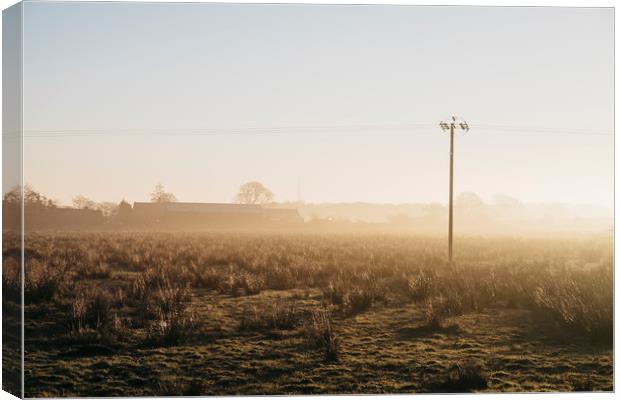 Telegraph pole and barn in fog at sunrise. Derbysh Canvas Print by Liam Grant