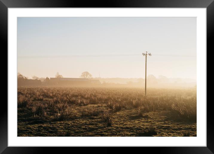 Telegraph pole and barn in fog at sunrise. Derbysh Framed Mounted Print by Liam Grant